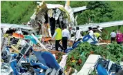  ??  ?? Officials inspect the wreckage of an Air India Express jet at Calicut Internatio­nal Airport in Karipur, Kerala. (AFP)