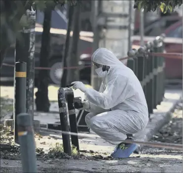  ?? Picture: AP ?? a forensics officer at the scene; the ambassador praised the ‘swift response’ of the police