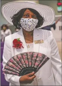  ??  ?? A woman wearing a face mask attends a church service at the New Horizon Internatio­nal Church in Jackson, Miss.