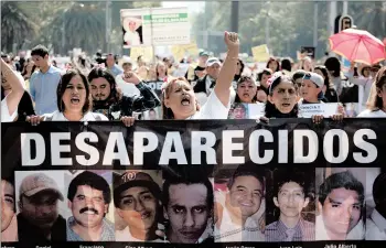  ?? EDUARDO VERDUGO/AP ?? Women carry a banner calling attention to the cases of people who have gone missing in the fight against drug cartels and organized crime, demanding authoritie­s locate their loved ones, as they mark Mother’s Day in 2018 in Mexico City.