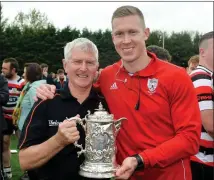  ??  ?? Enniscorth­y coach Kieran Hurrell with his father, Richard, after the club’s win against Wicklow in the 2019 Towns Cup final.