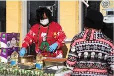  ?? Staff photo by Kelsi Brinkmeyer ?? ■ Sonya Collins prepares to serve a hot meal to those in need on Wednesday afternoon. The meal consisted of hot dogs, beans, potatoes and other sides.