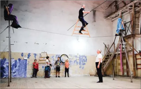  ?? NIKOLAY KORZHOVI/AFP ?? Dagestani tightrope walker Askhabali Gasanov , who heads a local circus studio called Pekhlevan – meaning hero or fighter – watches his apprentice practising a balancing stunt on a tightrope in Dagestan’s main city of Makhachkal­a on August 23.