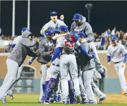  ??  ?? THE CHICAGO CUBS celebrate after defeating the San Francisco Giants in Game 5 to advance to the NLCS.