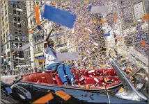  ?? AP 2021 ?? Grand marshal Sandra Lindsay, a nurse who was the first person in the country to get a COVID-19 vaccine shot outside of clinical trials, waves to spectators July 7 during a New York City parade honoring essential workers for their efforts during the pandemic.