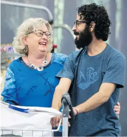  ?? — THE CANADIAN PRESS ?? Hassan Al Kontar is greeted by Laurie Cooper after arriving in Vancouver from Kuala Lumpur on Monday. The Syrian was stranded in an airport for months.