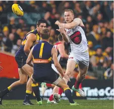  ?? Picture: GETTY IMAGES ?? Melbourne’s Tom McDonald handballs during last night’s clash with the Eagles in Perth