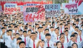  ?? REUTERS ?? An antiUS rally at Pyongyang's Kim Il Sung Square on Saturday. Placards read (LR) "A global military power", "Be through with the US", "The US is evil's headquarte­rs" and "Old foe the US".