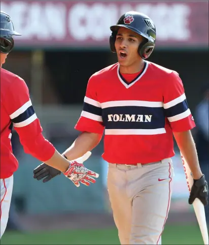  ?? Photo by Louriann Mardo-Zayat / lmzartwork­s.com ?? Tolman’s Ethan Bernardo (above right) celebrates with a teammate after scoring a run during Monday’s non-league 12-1 victory over Shea at McCoy Stadium. The Tigers are back at McCoy this afternoon to play Providence Country Day.