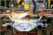  ?? ASSOCIATED PRESS FILE PHOTO ?? Machines work on a Ford vehicle assembly line at Ford’s Chicago Assembly Plant in Chicago.