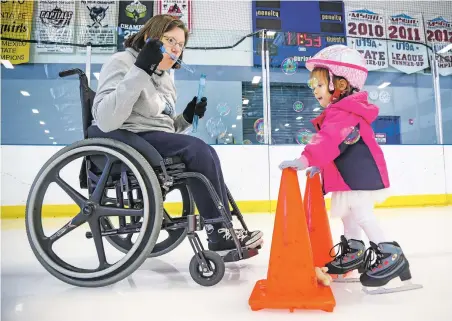  ?? GABRIELA CAMPOS/THE NEW MEXICAN ?? Tammy Berendzen, president of Santa Fe Skating Club, blows bubbles for Thea Stofick, 2, during a learn-to-skate lesson at the Genoveva Chavez Community Center ice rink. Berendzen has been selected as one of the 10 Who Made a Difference in 2018.