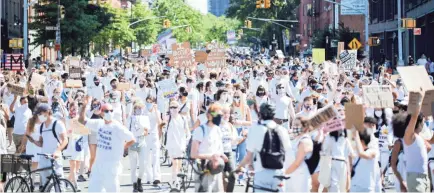  ?? MICHAEL NOBLE JR./GETTY IMAGES ?? Thousands fill the streets in support of Black Trans Lives Matter and George Floyd on June 14 in Brooklyn, N.Y.