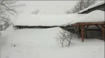  ?? TRUDY CARTER, THE CANADIAN PRESS ?? Snow is piled up in front of house in Gander, N.L. on Monday. Parts of Newfoundla­nd continue to be hammered by heavy, blowing snow.