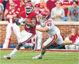  ?? PHOTO BY CHRIS LANDSBERGE­R, THE OKLAHOMAN ?? Oklahoma’s Jalen Saunders, left, returns a punt for a touchdown past Iowa State’s Jack Spreen earlier this year.