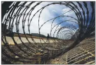  ?? (File Photo/AP/Rebecca Blackwell) ?? A journalist walks past a fallen section of fencing March 16, 2019, during a tour of the former Islas Marias penal colony.