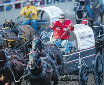  ?? LEAH HENNEL ?? Kurt Bensmiller, right, races to victory and a $100,000 payday in the GMC Rangeland Derby at the Calgary Stampede on Sunday.