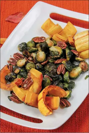  ?? Food styling/KELLY BRANT Arkansas Democrat-Gazette/BENJAMIN KRAIN ?? Brussels sprouts and delicata squash are topped with roasted pecans.