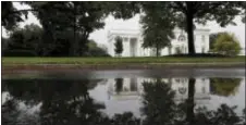  ?? ALEX BRANDON - THE ASSOCIATED PRESS ?? The White House in Washington is seen reflected in a rainwater puddle, Friday. The White House and the Capitol sit two miles apart, but this week, they might as well have been two worlds away. Republican­s labored over health care while White House...