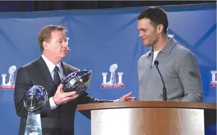  ??  ?? NFL COMMISSION­ER Roger Goodell (L) presents New England Patriots quarterbac­k Tom Brady (R) with the Pete Rozelle Trophy as Super Bowl LI most valuable player at the George R. Brown Convention Center.