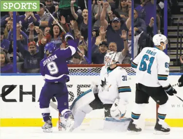  ?? Chris O'Meara / Associated Press ?? The Lightning’s Tyler Johnson celebrates after scoring past Sharks goalie Martin Jones in the third period.