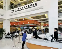  ??  ?? The clientele of the China (Shanghai) Pilot Free Trade Zone administra­tive service center grows daily.