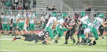  ??  ?? Blackhawk defenders Justin Stamps, No. 82; Josh Ford, No. 29, Bradley Beavers, No. 1, try to stop Greenland’s ball carrier Friday night in the first varsity game on home turf.