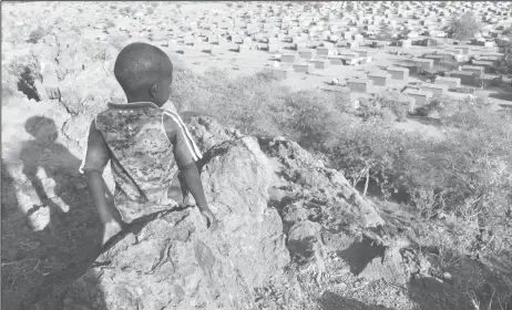  ?? ?? Boy overlooks a refugee camp near the Chad-Sudan border. Hundreds of Masalit families from Sudan’s West Darfur state are at the camp after being driven across the border in an ethnically targeted campaign by Arab forces. About half a million people, mostly Masalit, have fled Sudan for Chad. (Reuters photo)