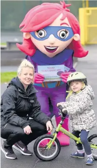  ??  ?? ●●Poppy-Anne Dale trying out the balance bikes with Leigh-anne Carnall from Link4Life