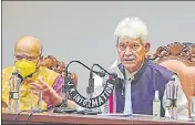  ?? PTI ?? Jammu and Kashmir Lt Governor Manoj Sinha with chief secretary BVR Subrahmany­am in Srinagar on Saturday.