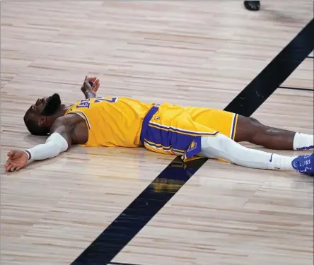 ?? ASHLEY LANDIS ?? Los Angeles Lakers forward Lebron James (23) lies on the court after committing a foul during the second half of an NBA basketball game against the Portland Trail Blazers Tuesday, Aug. 18, 2020, in Lake Buena Vista, Fla.