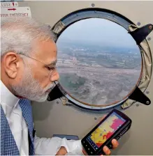  ?? PTI ?? Prime Minister Narendra Modi during an aerial survey of flood affected areas of Banaskatha districts of Gujarat. —