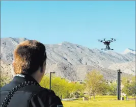  ?? JERRY HENKEL/ LAS VEGAS REVIEW-JOURNAL ?? Nevada Highway Patrol trooper Daniel Marek controls a Yuneec Typhoon H unmanned aerial vehicle on Friday during a news conference at Lone Mountain Regional Park.