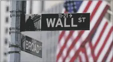  ?? AP PHOTO/SETH WENIG ?? A street sign is seen in front of the New York Stock Exchange in New York, on June 14.