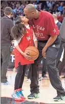  ?? AP-Mark Blinch ?? In this Feb. 14, 2016, file photo, Los Angeles Lakers Kobe Bryant (24) kisses his daughter Gianna on the court in warmups in Toronto. Bryant, his 13-year-old daughter, Gianna, and several others are dead after their helicopter went down in Southern California on Jan. 26.