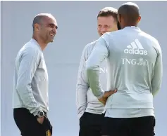  ??  ?? Belgium’s assistant coach Thierry Henry (right) speaks with Belgium’s coach Roberto Martinez (left) during a training session of Belgium’s national football team at the Guchkovo Stadium in Dedovsk, outside Moscow. — AFP photo