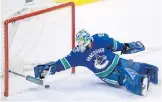  ?? THE CANADIAN PRESS ?? Canucks goalie Anders Nilsson keeps the puck out of the net without his stick during the second period against the St. Louis Blues in Vancouver on Saturday. Story, B3.