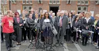  ?? AFP ?? Marcia Willis-Stewart (centre), legal representa­tive for family members affected by the 1989 Hillsborou­gh stadium disaster, speaks outside Parr Hall after the families were informed of the decision. —