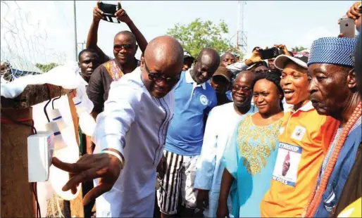  ??  ?? Hon. Oladele inaugurati­ng the electrific­ation project while the facilitato­r, Sanusi (fourth from right) and others look on