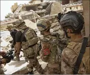  ?? MAYA ALLERUZZO / AP ?? Iraqi special forces advance to their next position in the Islah al-Zarai area in Mosul, Iraq, recently. The Islamic State’s grip on the city is slipping.