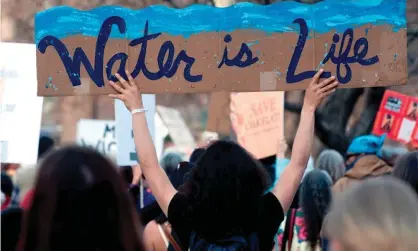  ??  ?? Native Americans and indigenous rights activists march and hold up signs in protest during a NativeNati­ons March in Denver, Colorado on 10 March 2017. Photograph: Jason Connolly/AFP/Getty Images