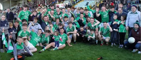  ??  ?? The Naomh Eanna players celebratin­g with their mentors and supporters after Sunday’s county final success.