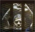  ?? DESOUKI/AFP KHALED ?? Ousted Egyptian president Mohamed Morsi gesturres from the defendants cage as he attends his trial on June 2, 2015.