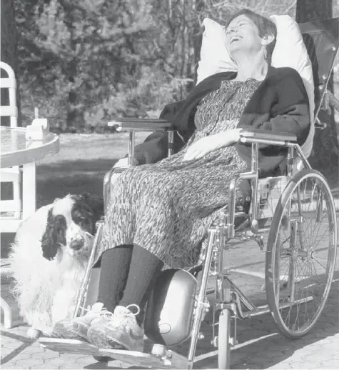  ?? POSTMEDIA NEWS FILES ?? Uncommon Will, the Death and Life of Sue Rodriguez is the new book describing the final years of Sue Rodriguez, shown here laughing at her dog at home
in North Saanich, B.C., last year. Rodriguez, who suffered from ALS, died earlier this year.