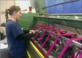  ?? PHOTOS BY SHIREEN KORKZAN VIA AP ?? Debbie McDermott’s daughter, Jamie Sparks, ties freshly-spun yarn into skeins. Sparks’ raising of two sheep for a 4-H project inspired her mother to establish Stonehedge Fiber Mill in East Jordan, Mich., on the family’s 165-year-old farm in 1999.