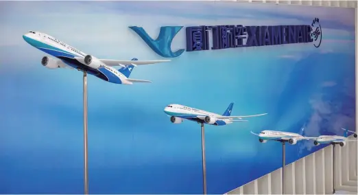  ??  ?? Plane models displayed at the headquarte­rs of Xiamenair, China’s only airline company that has been making profits for 32 years in a row