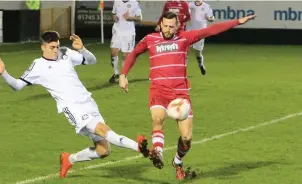  ??  ?? Former Bala player Mike Hayes (right) hit two crucial goals for Caernarfon against Barry Town Utd at the weekend in the playoff semi-final