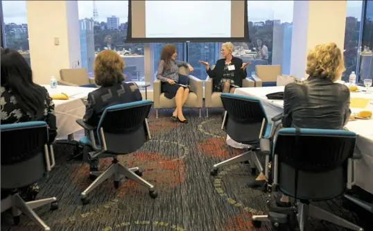  ?? Steph Chambers/Post-Gazette ?? Sarah Stewart, center right, director of Industrial Search Partners, answers questions from Michele Fabrizi of Marc USA during a May 11 session held by Deloitte to prepare women to join corporate boards at One PPG Place, Downtown.