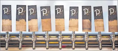  ?? [BROOKE LAVALLEY/DISPATCH] ?? At the Pretentiou­s Barrel House on the Near East Side, the taps are all connected to sour beers.