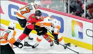  ?? ?? Philadelph­ia Flyers’ Ronnie Attard (47), Chicago Blackhawks’ Dylan Strome (17) and Flyers’ Ivan Provorov (9) battle for the puck behind the Flyers’ goal during the second period of an NHL hockey game on April 25, in Chicago. (AP)