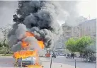  ??  ?? Flames engulf a car during clashes between protesters and Lebanese soldiers in the northern port city of Tripoli on Tuesday.